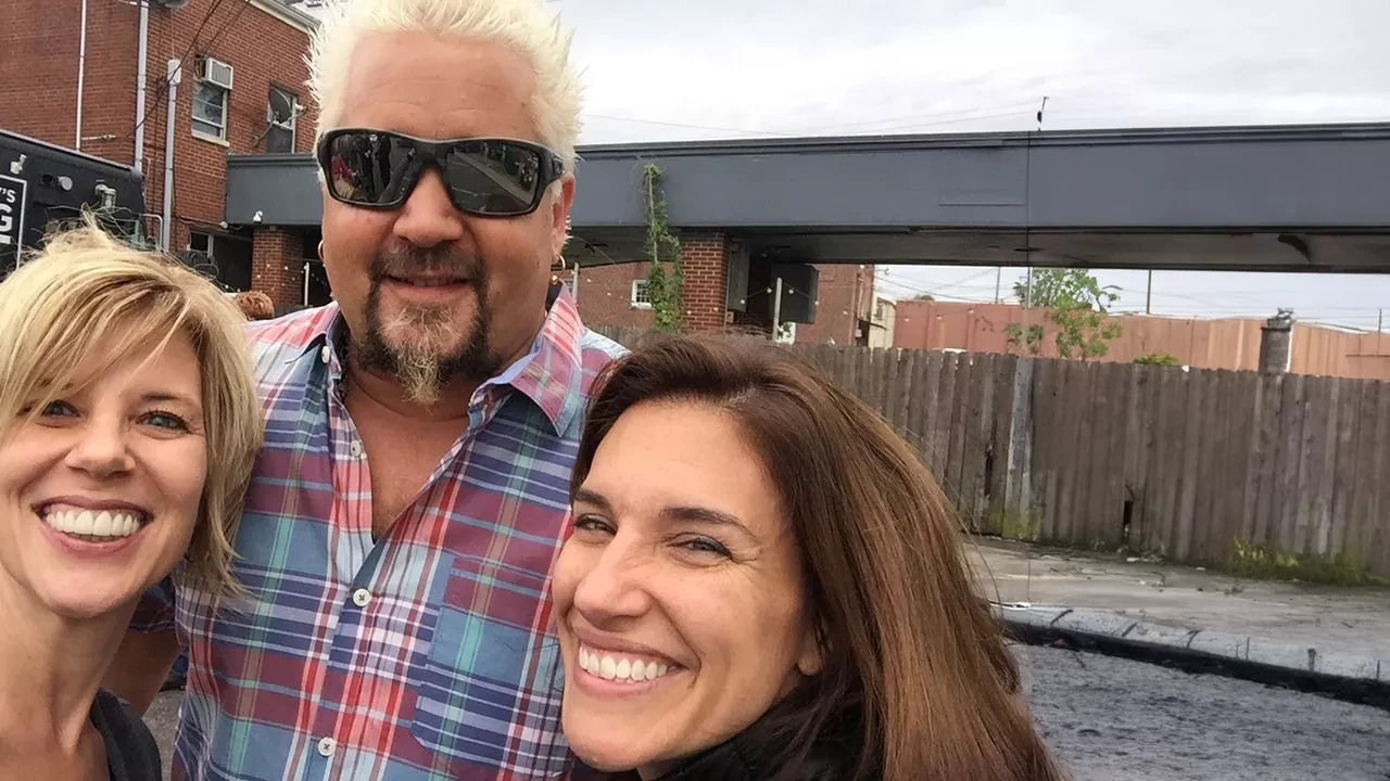 Sarah and another person taking a selfie with Guy Fieri