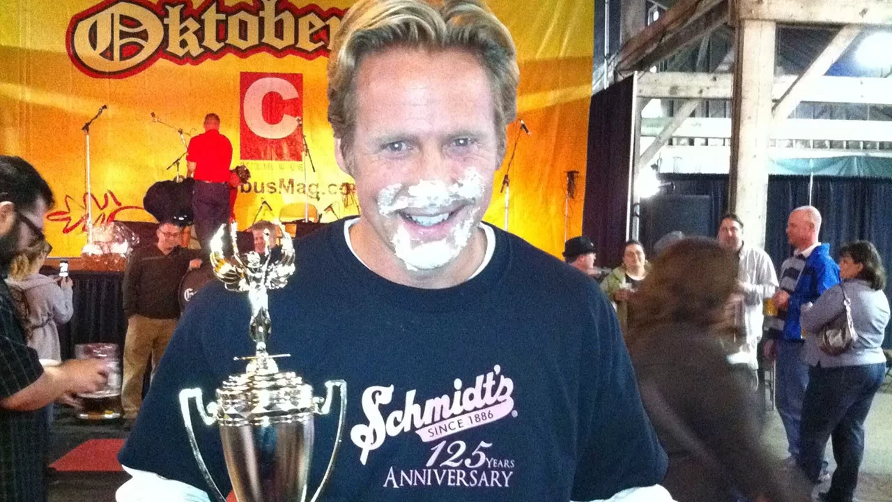 Puff Challenge Winner holding trophy with puff on their face